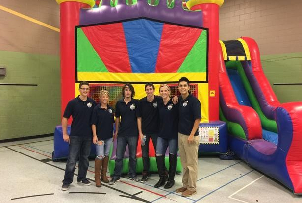 staff posing infront of inflatable