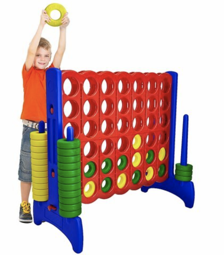 kid playing with giant connect four